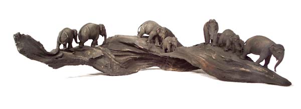 Wooden root with seven elephants
